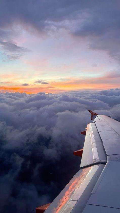 View from the airplane of clouds and the ground below